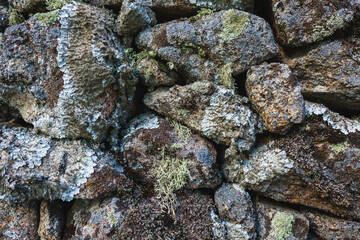 A close-up view of a rustic stone wall with irregularly shaped rocks