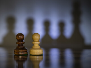 Chess pieces symbolize geopolitical and social relations. Their positions and shadows allow viewers...
