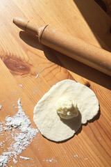 There is a dough with filling on the table