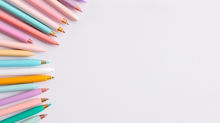 Fototapeta premium Pastel Ballpoint Pens Arranged Diagonally on White Background with Ample Copy Space, Ideal for Clean, Minimalistic, and Artistic Stationery Photography for School or Office Supplies