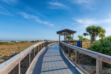 Elevated boardwalk trail in New Smyrna Dunes Park in sunny day in New Smyrna Beach, Florida