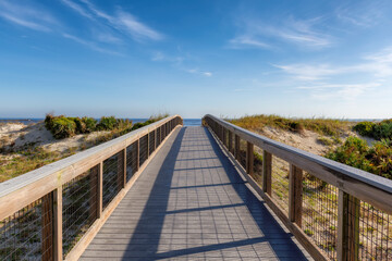 New Smyrna Beach, Elevated boardwalk trail in New Smyrna Dunes Park in sunny day in New Smyrna Beach, Florida