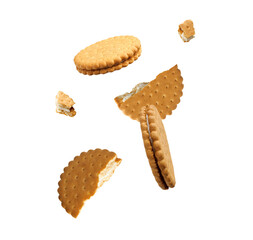 Tasty broken sandwich cookies in air on white background