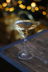 defocus background blurred lights on the tree, drink cocktail or champagne. celebrate holidays. home comfort. free space for text holiday season New Year and Christmas