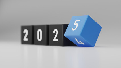 Close-up of black and blue dice showing year transition from 2024 to 2025 on gray background, symbolizing new year