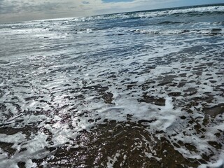 Entering the ocean, in the coast, going inside to the water