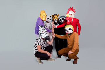 Full size photo of zebra gorilla raccoon lion panda sloth rooster mask people pile stack arms hold...