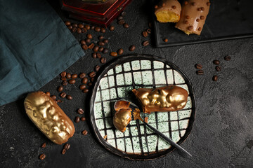 Composition with sweet eclairs and coffee beans on dark background