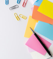 A close-up of a neatly stacked pile of colorful sticky notes, showcasing vibrant hues that add a lively touch to any organized workspace.
