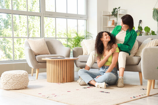 Young lesbian couple sitting at home