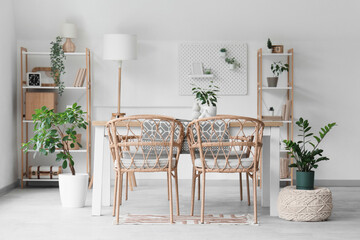 Interior of stylish modern room with shelving units, table and chairs