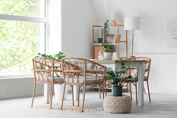 Interior of stylish modern room with shelving unit, table and chairs
