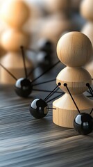 Obraz premium Wooden figures connected by black lines illustrate the concept of social and business networking against a vibrant blue background