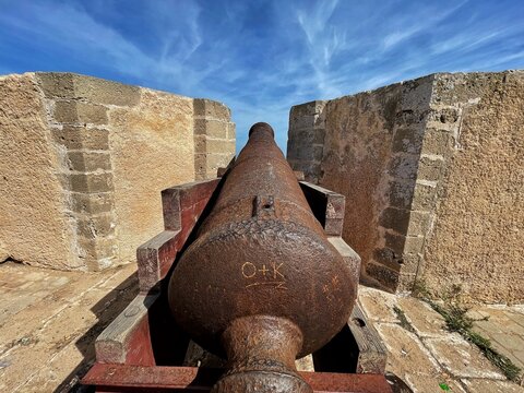 Close up of a cannon on the City Walls of Mazagan in El Jadida, Morocco at sunset. The City Wall around the old city. It is a Portuguese Fortified Port City registered as a UNESCO World Heritage