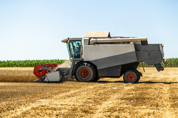 Modern combine harvester at work during the wheat harvest season