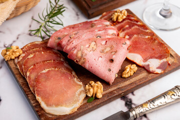 cold cuts table with assorted cheeses, Sardinian provolone and flavoured with oregano and olives,...