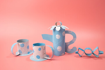 a couple of cups and a teapot on a pink surface, a still life, trending on polycount, conceptual art, paper craft for kids