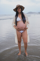 a pregnant woman on the beach