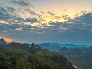 Fototapeta premium Wuyi Mountain, Fujian Province - The view of the mountains against the sky at sunrise
