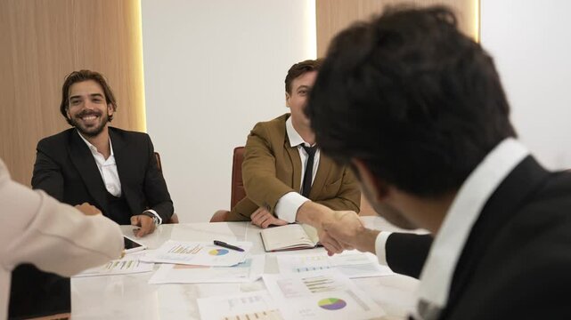 Ornament meeting room with group of diversity business people or office worker college shake hand with TV screen display company's successful marketing plan from hardworking as team.