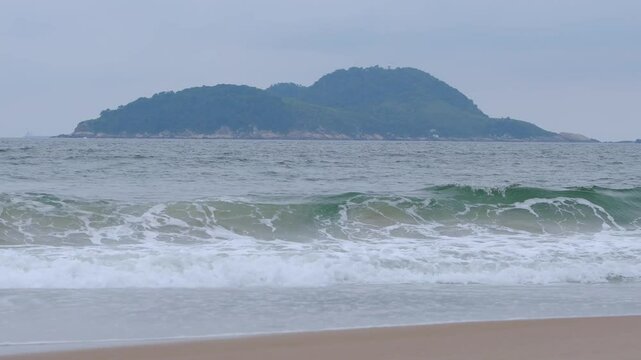 The Tombo beach of Guaruja - SP, Brazil with the Farol da Moela island on background. Landscape of the beach with no people.