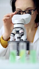 Woman scientist using microscope in laboratory. Microbiology science concept