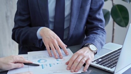 Two professionals analyzing a pie chart during a strategic business meeting. Business meeting with graph analysis
