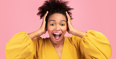 Omg. Close up portrait of hipster afro woman with brown curly hair grabbing head isolated over pink...
