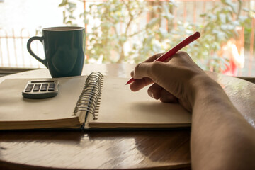 Business plan. Close-up view of a man doing some business calculations