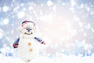 A cheerful snowman dressed in a colorful winter hat and scarf, standing against a snowy, sparkling...