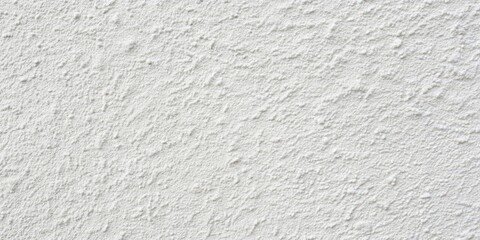Fototapeta premium A close-up view of a white, textured wall with a subtle, irregular pattern of small bumps