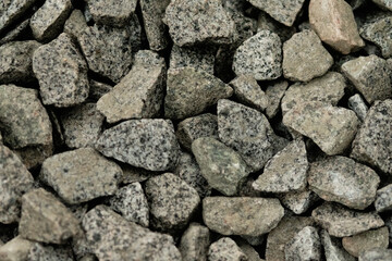 Smooth round pebbles texture background. Pebble sea beach close-up, dark wet pebble and gray dry pebble. High quality photo