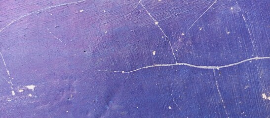 Mixed rough paint splatter on a textured blue paint surface