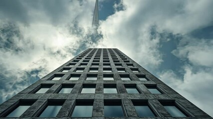 Towering brutalist skyscraper with a grid of recessed windows, set against a cloudy sky, emphasizing its monumental scale and raw materiality. . Video