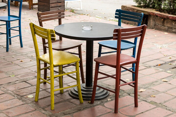 Street view of a coffee terrace with tables and chairs