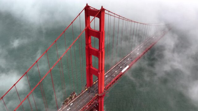 San Francisco - Thick Fog Rolling Past Golden Gate Bridge - High Aerial Shot