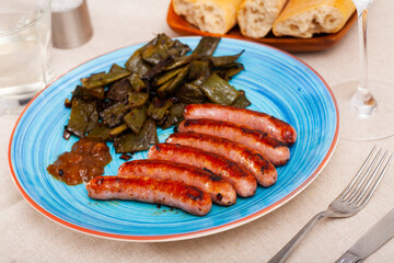 Tasty fried meat sausages served with stewed green beans at plate