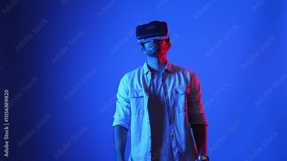 Poster smart gamer wearing vr goggles while holding sword and fencing in virtual world. attractive male mod