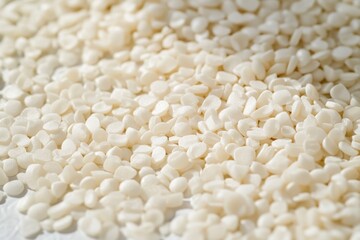 Plastic raw material granules, with a focus on their glossy texture and uniform size, suitable for use in high-precision applications.