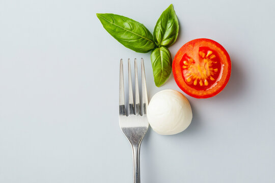 Classic Italian tomato and mozzarella capresse salad wit a fork