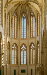 Majestic Gothic architecture illuminated by sunlight in a historic church interior
