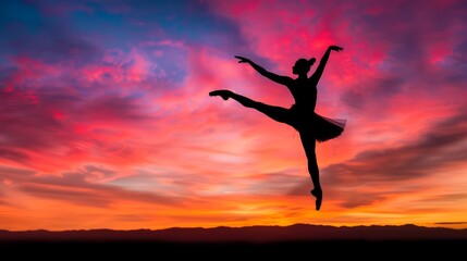Fototapeta premium Elegant Dancer Leaping Silhouette Against Sunset Sky
