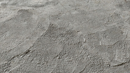 footprint in sand, rough cement wall texture background