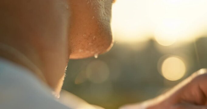 Closeup, man and tired with sweat for exercise, fitness and workout for marathon challenge outdoor. Male person, athlete or wipe face on zoom with breathing, running activity or training for wellness