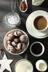 Delicious crinkle cookies in a plate, on a dark background.