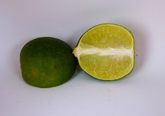 photo of young orange cut in half, on white background, look fresh