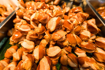 Golden Brown Fried Sausages for Sale in a Thai Street Food Market, Ready to Enjoy
