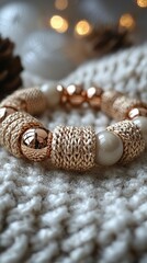 Elegant handmade bracelet with textured beads on cozy knitted background