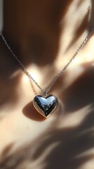 Silver heart pendant necklace with chain under soft sunlight