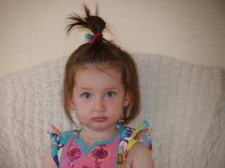 Capturing the Innocence: A Portrait of a Young Girl with Braided Hair, Symbolizing the Pure Joy and Simplicity of Childhood, Radiating Curiosity and Wonder in Her Expressive Eyes.